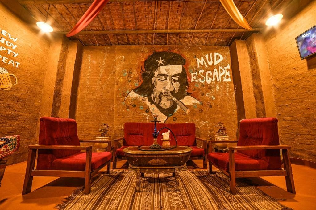 A seating corner with red armchairs and a painted mural