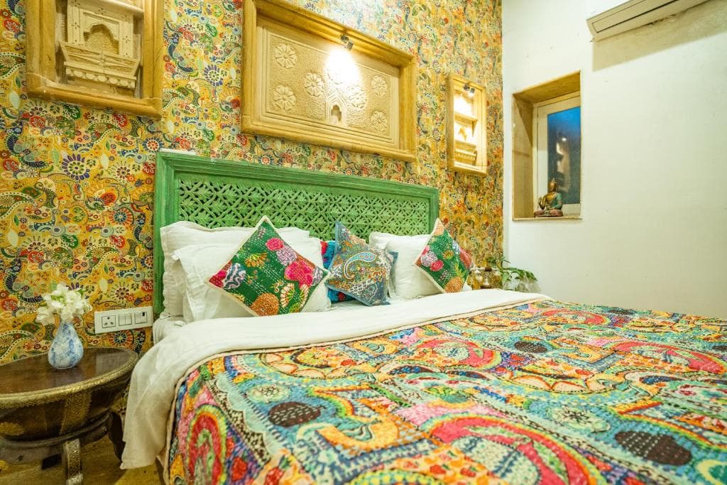 A hand-painted room with a carved green headboard